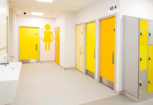 An image of a communal changing room with plain colour laminate fire doors